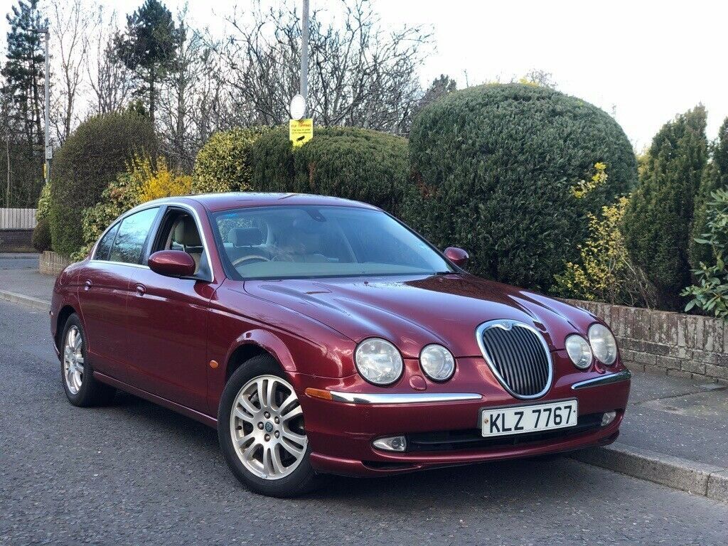 A red Jaguar S-Type R parked on the road