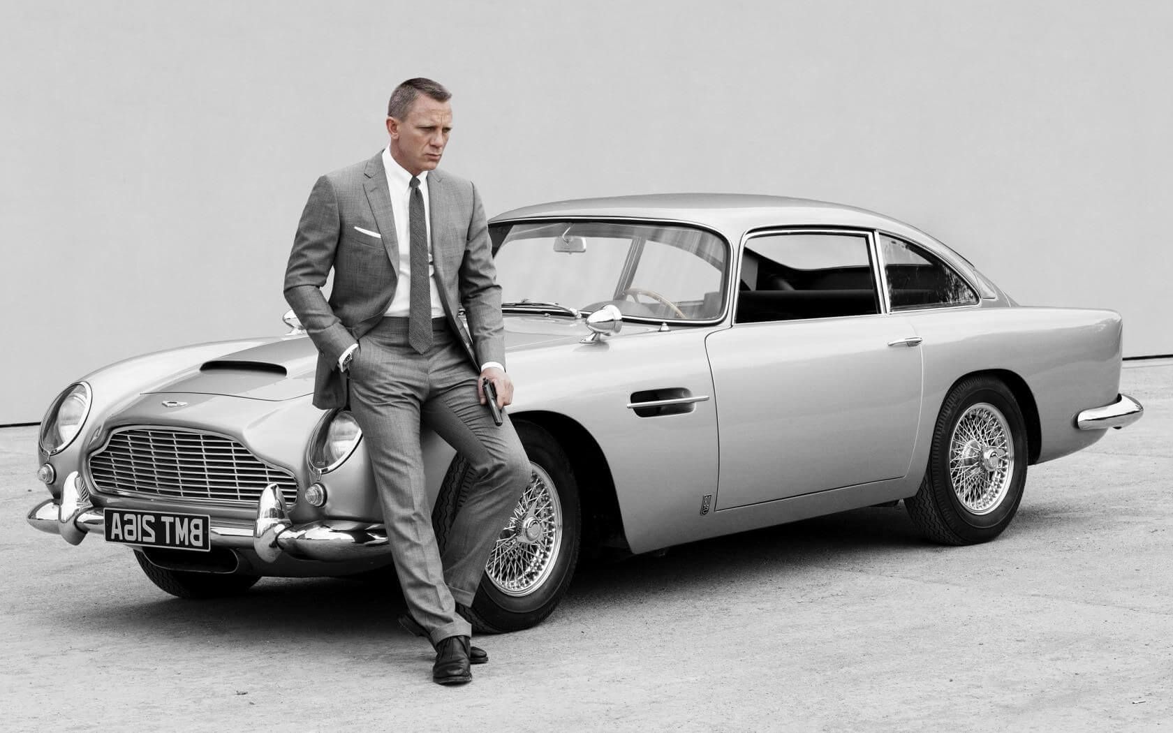 James Bond actor Daniel Craig sits on the iconic Aston Martin DB5