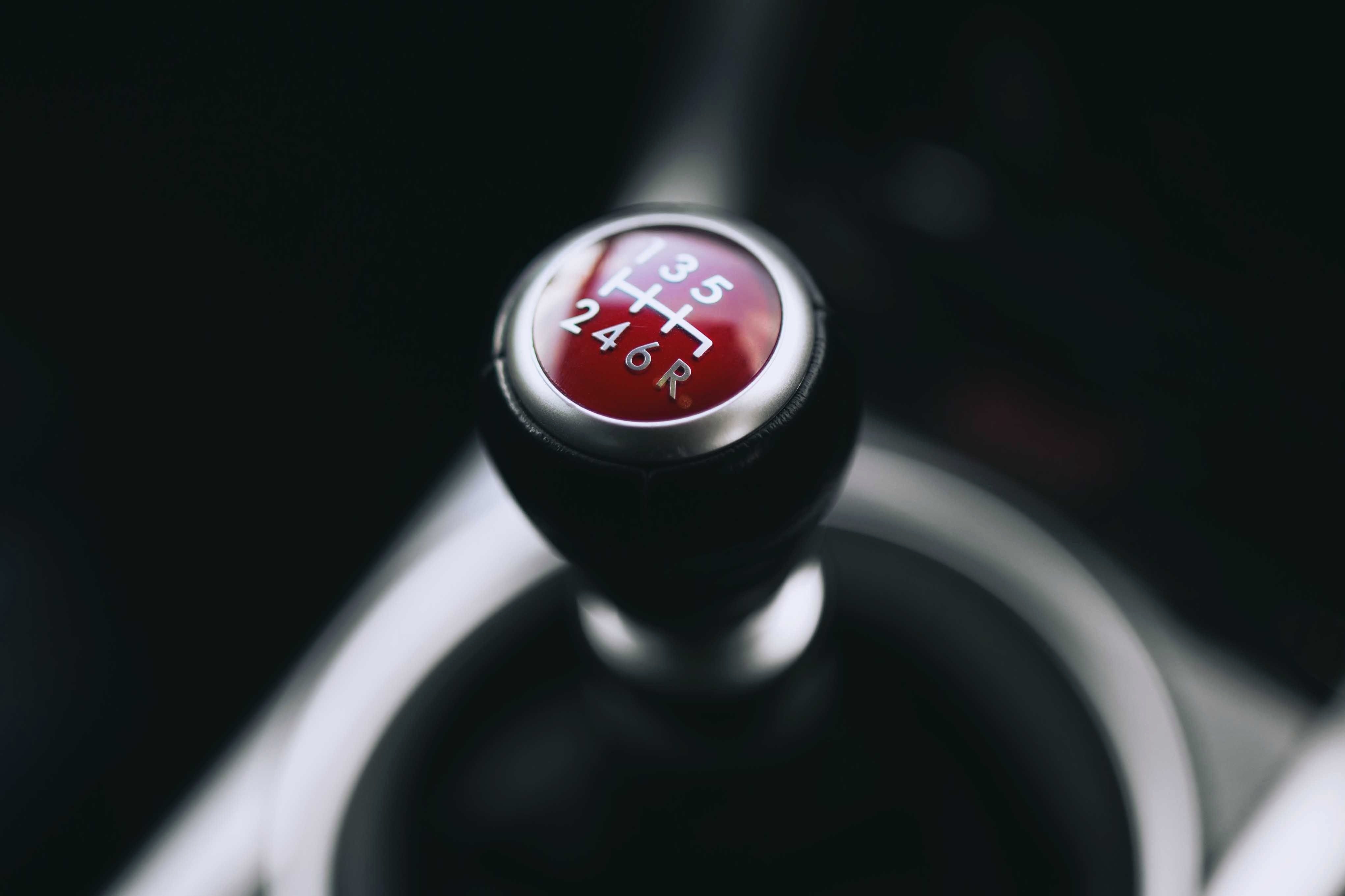 Close-up on red top stick shift