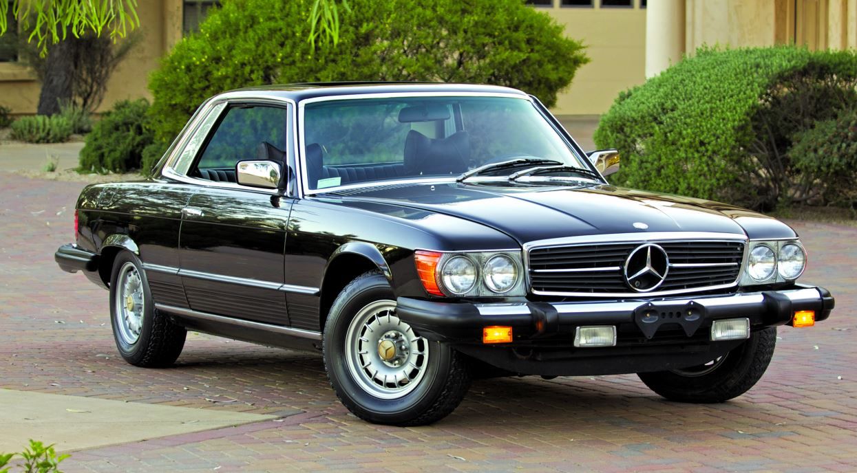 Black Mercedes-Benz 350SL C107 parked on the paved driveway
