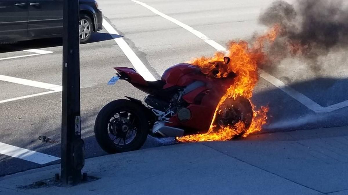 a Ducati Panigale V4 on fire on the side of the road