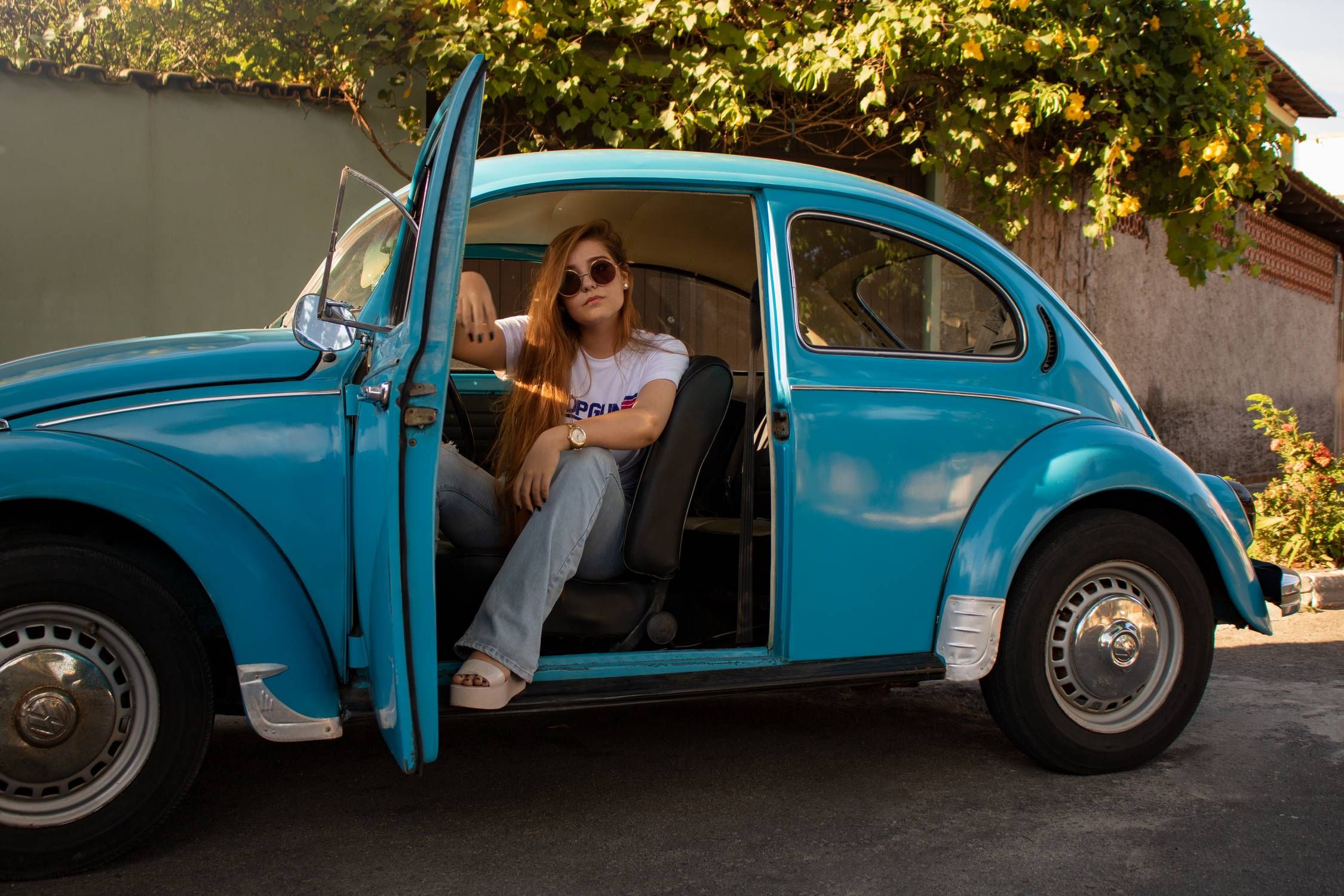 Blue VW Beetle with woman