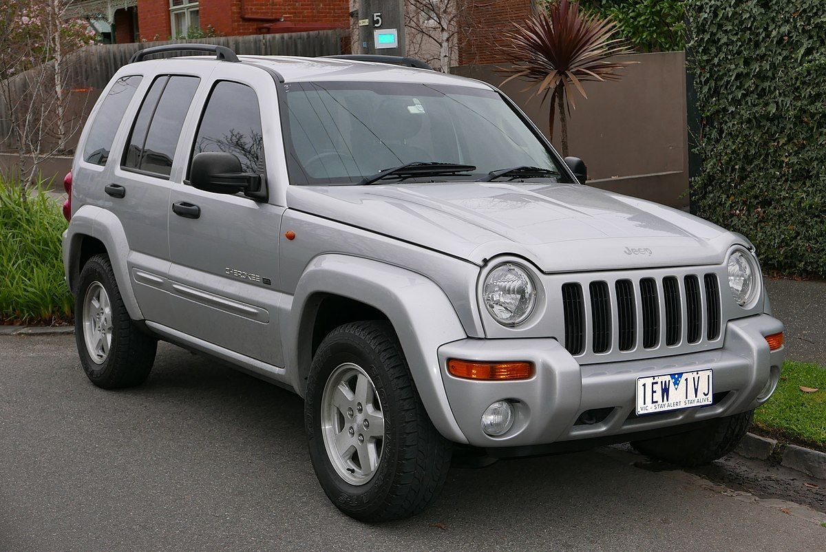A silver Jeep Liberty parked on a driveway.