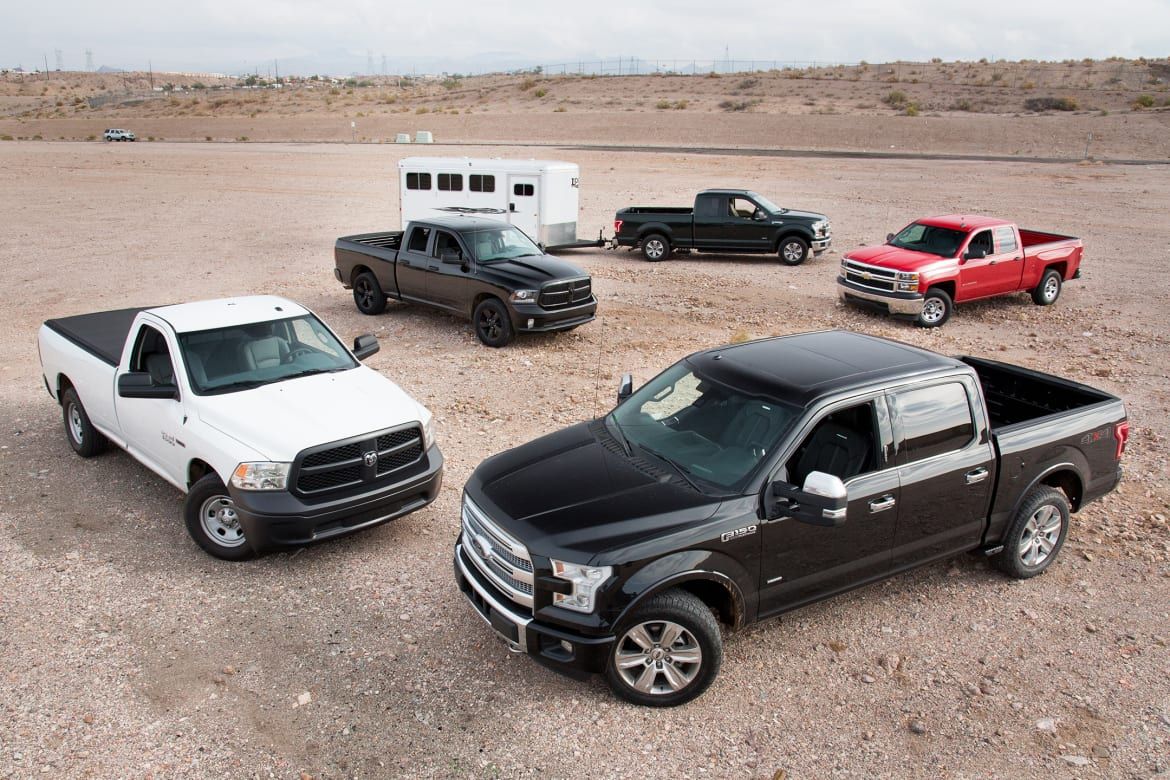 A bunch of American pickup trucks on the dirt
