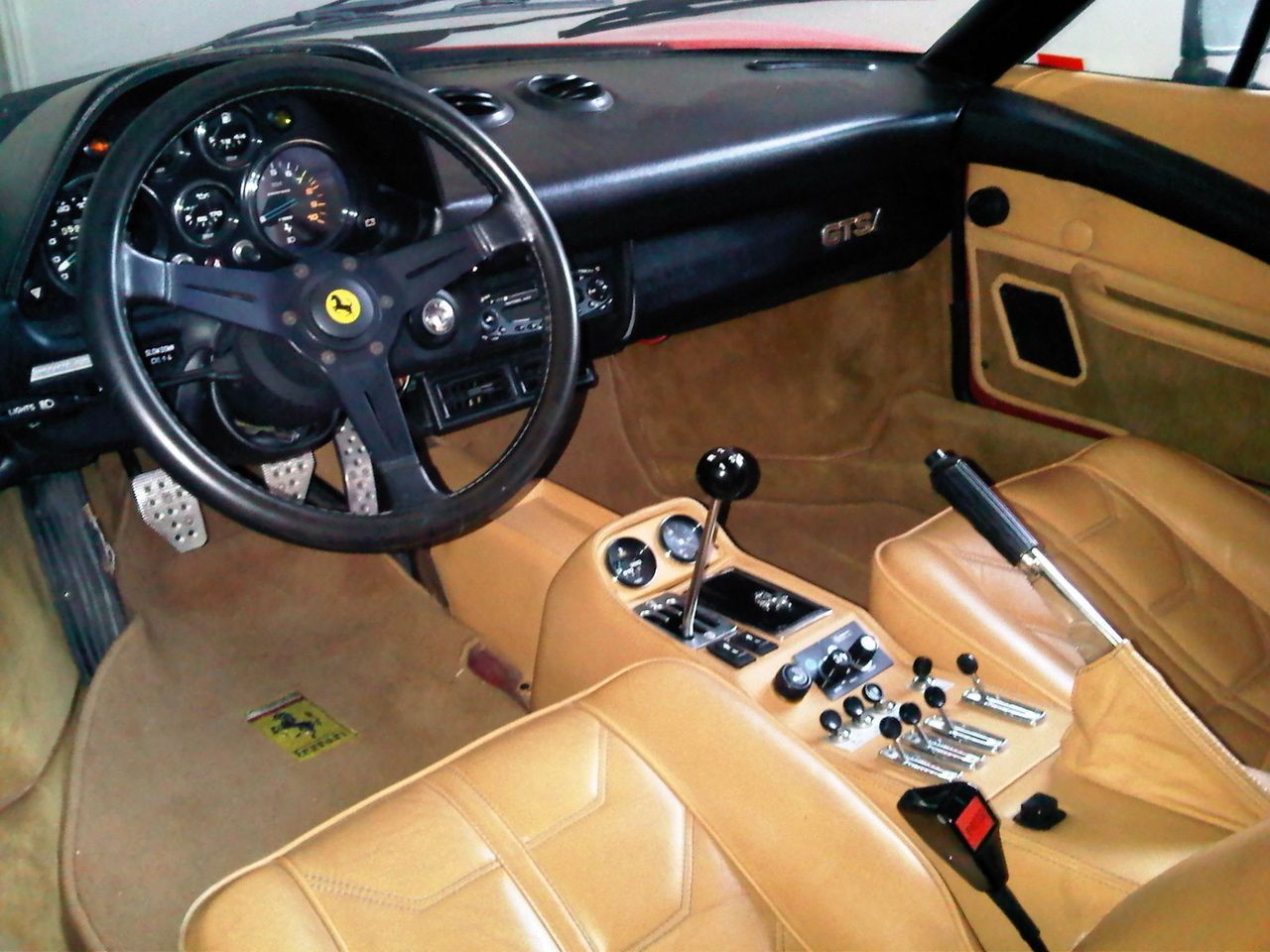 Interior of a Ferrari 308 with a manual transmission