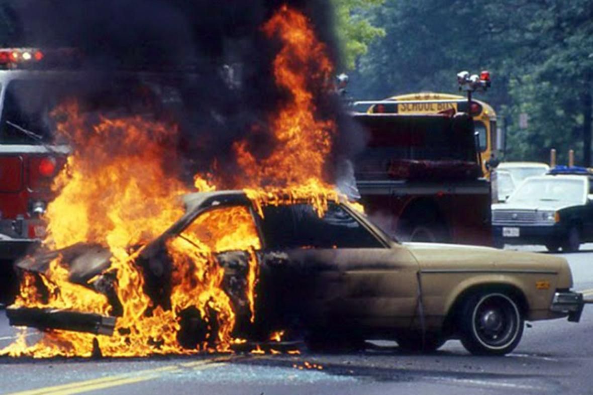 Ford Pinto on fire in the middle of the street
