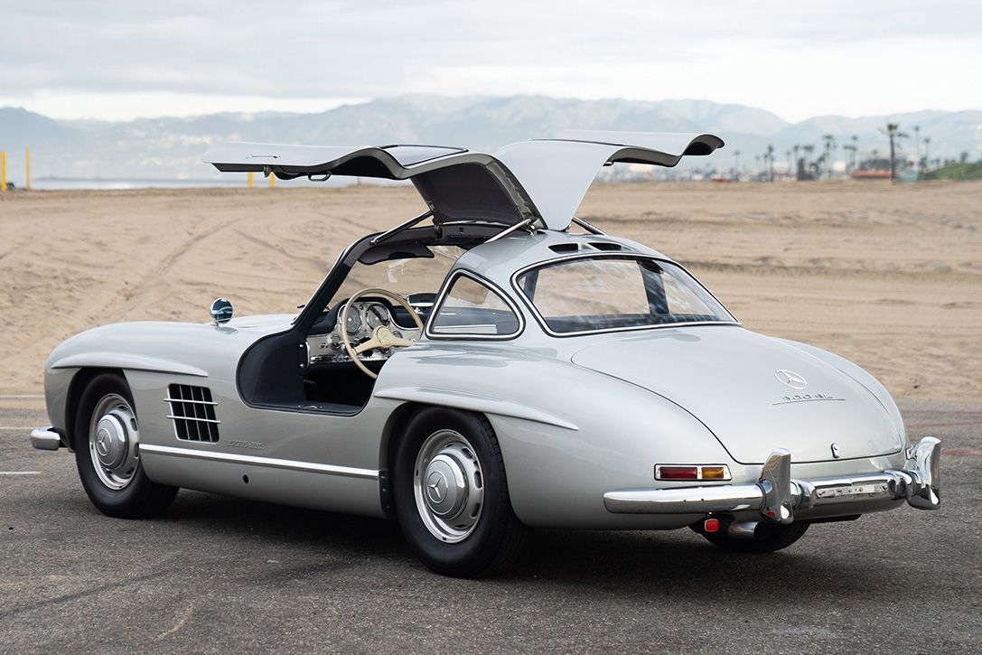 Silver Gray Metallic Mercedes-Benz 300SL Gullwing showing off with its doors open 