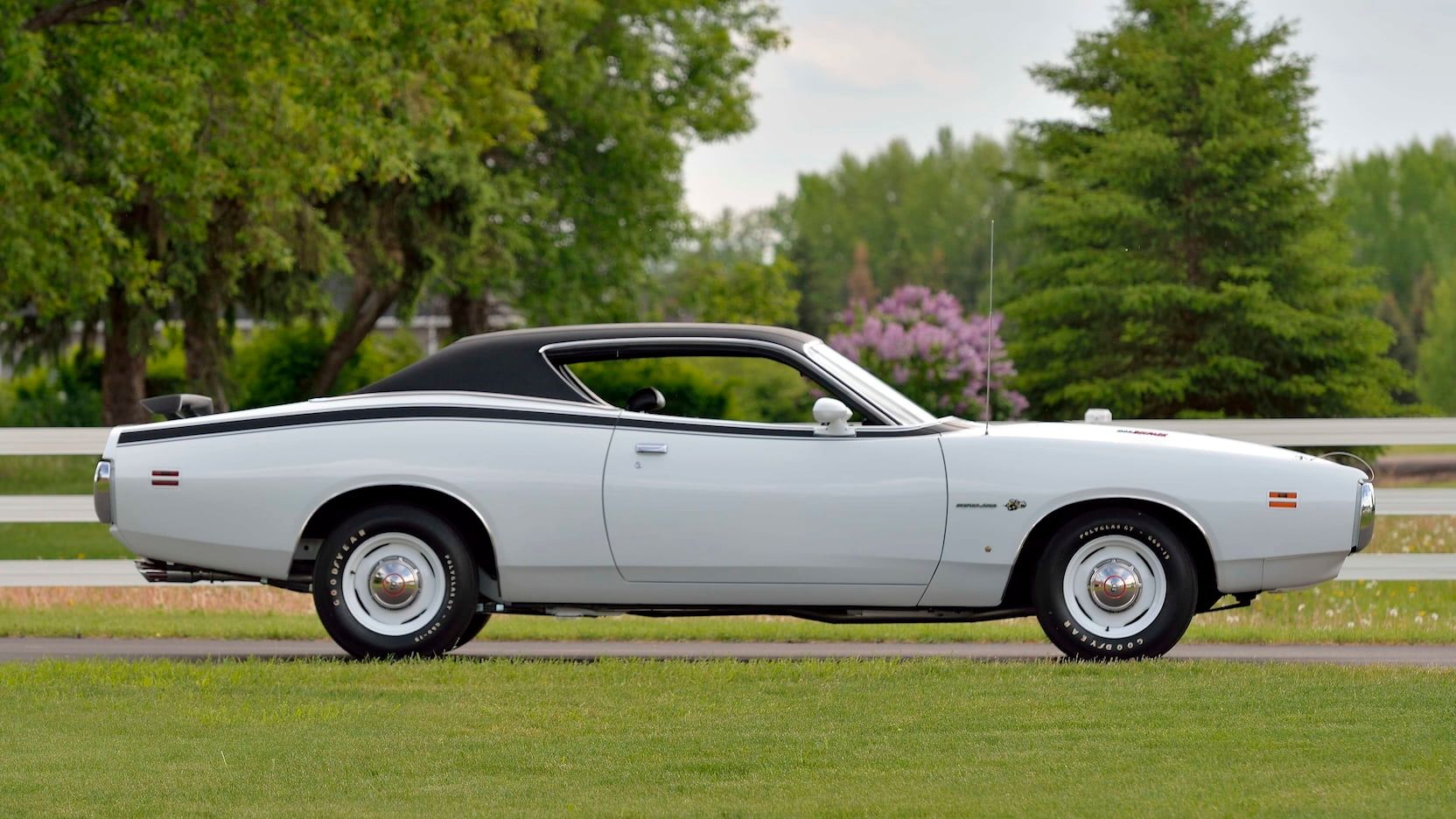 Side view of a Bright White 1971 Dodge Charger Super Bee on a driveway