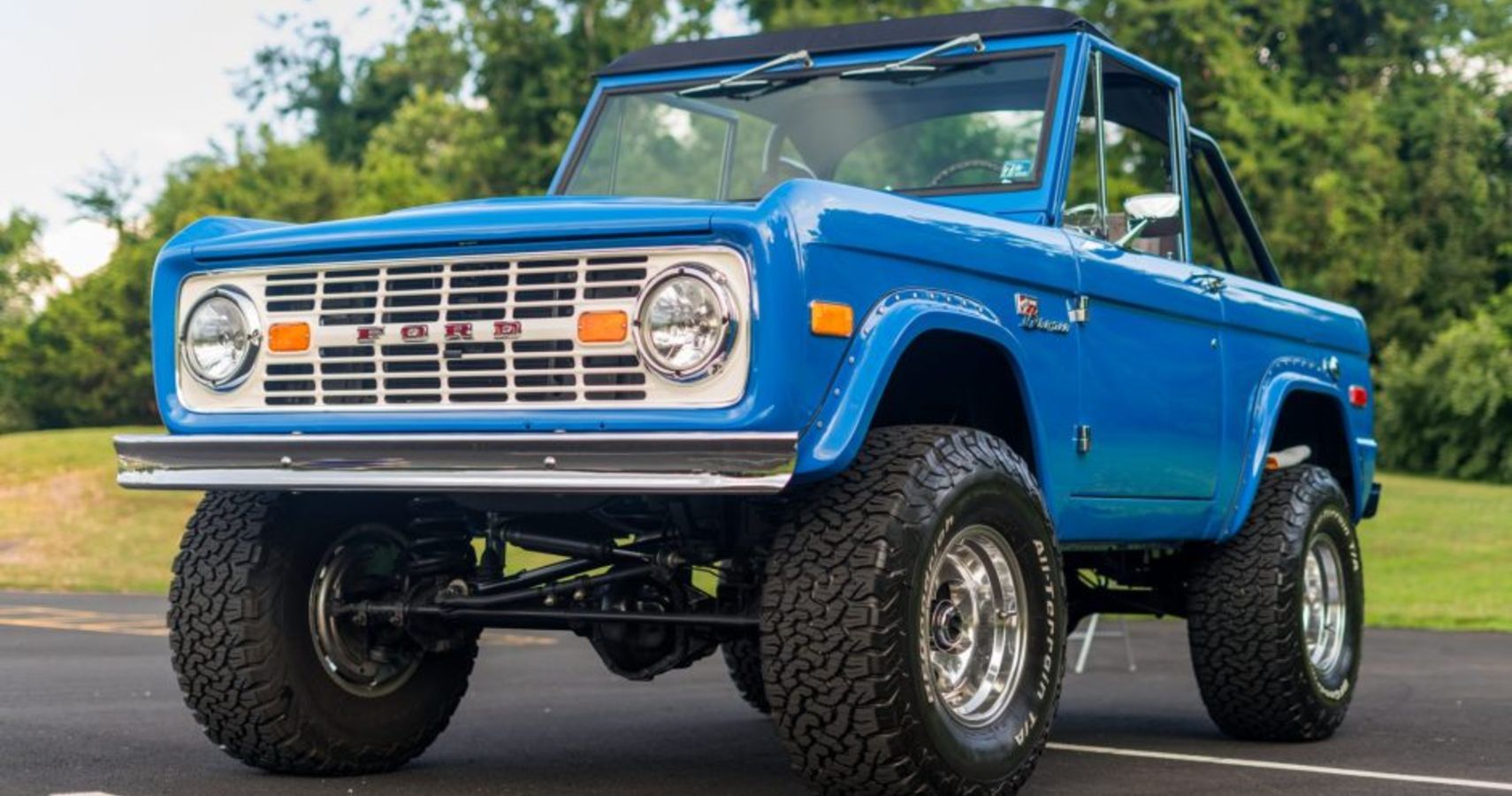 1974 Ford Bronco with chunky tires in blue parked