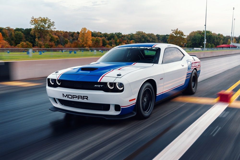 White and Blue 2020 Dodge Challenger speeding on the track