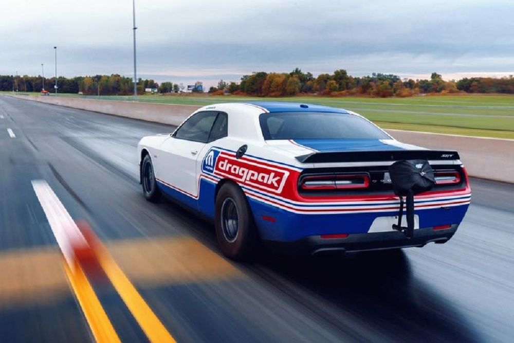 White and Blue 2020 Dodge Challenger speeding on the track