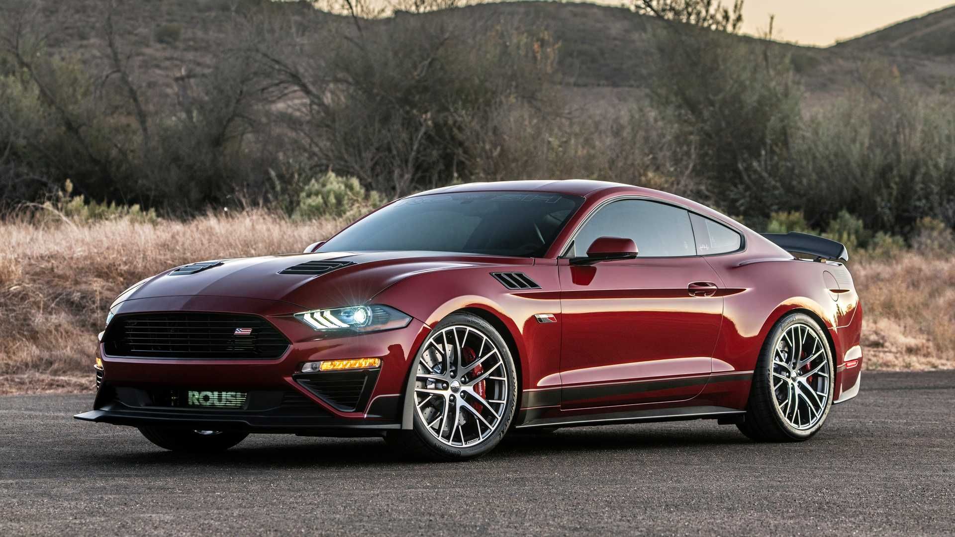 Dark red 2020 Ford Mustang Jack Roush Edition with its headlights on in the everning