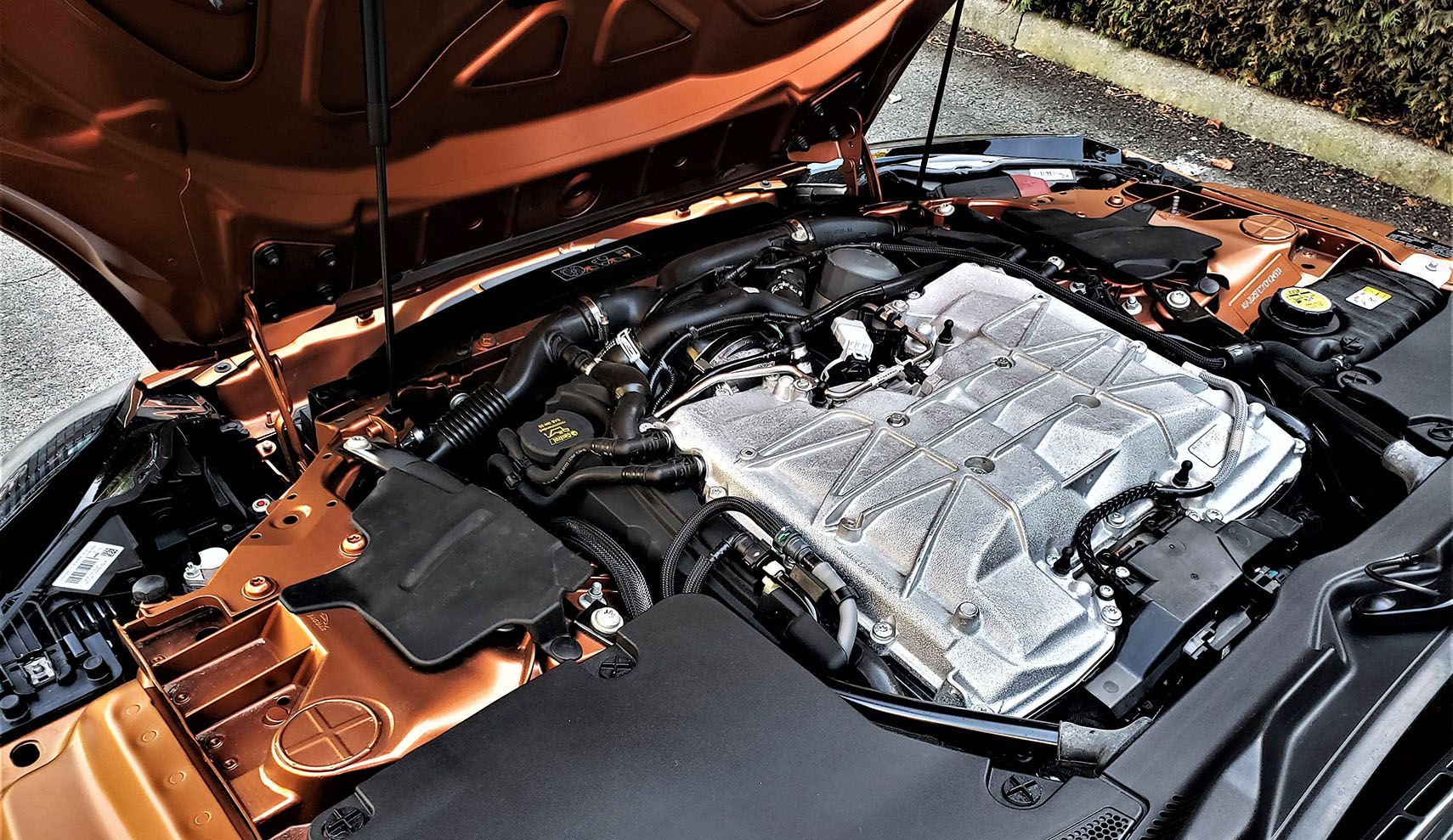 A reverse-hinged clamshell hood opens up to Jaguar's "well-proven" 575-hp V8.