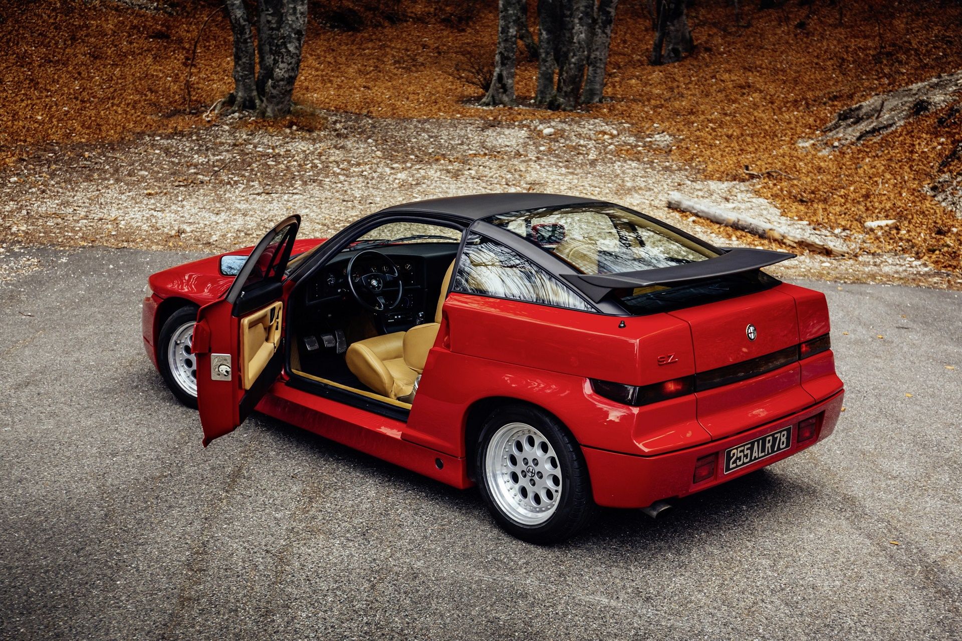 Red Alfa Romeo SZ on an autumn day with its driver door open