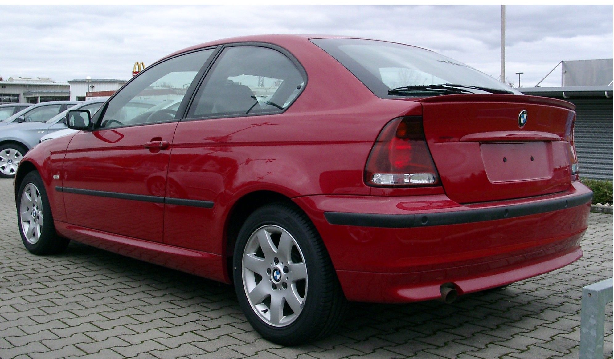 Red BMW 3 series compact rear