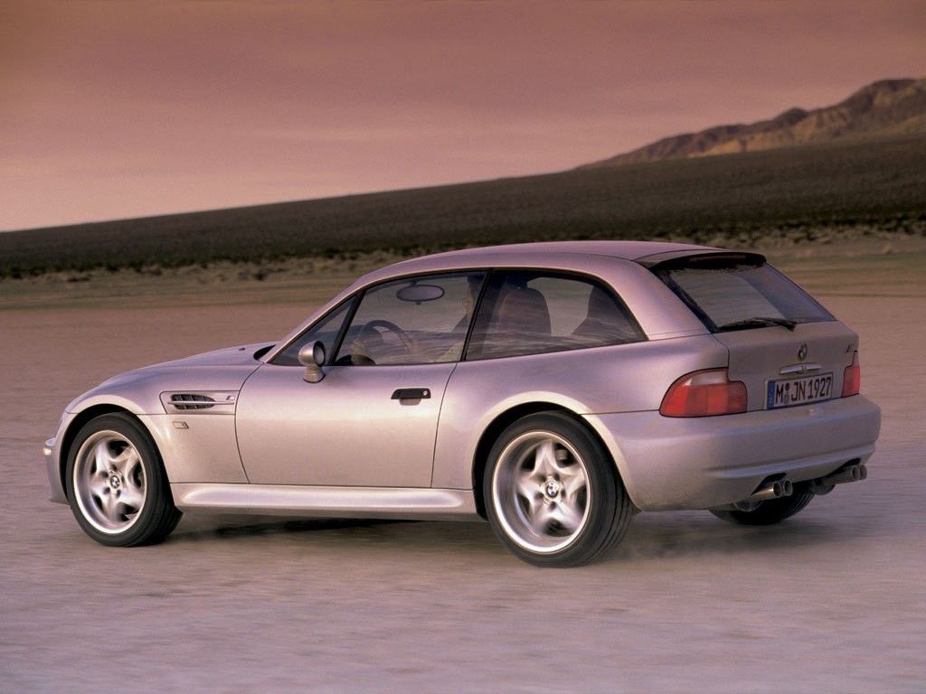 Titanium Silver Metallic BMW Z3 Coupe cruising on the salt lake at sunset