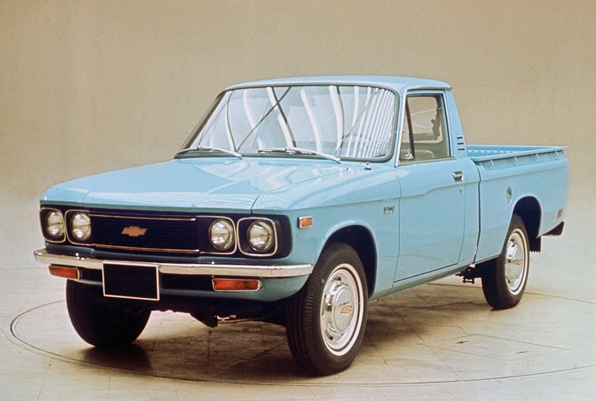 Blue Chevy Luv with beige wall background