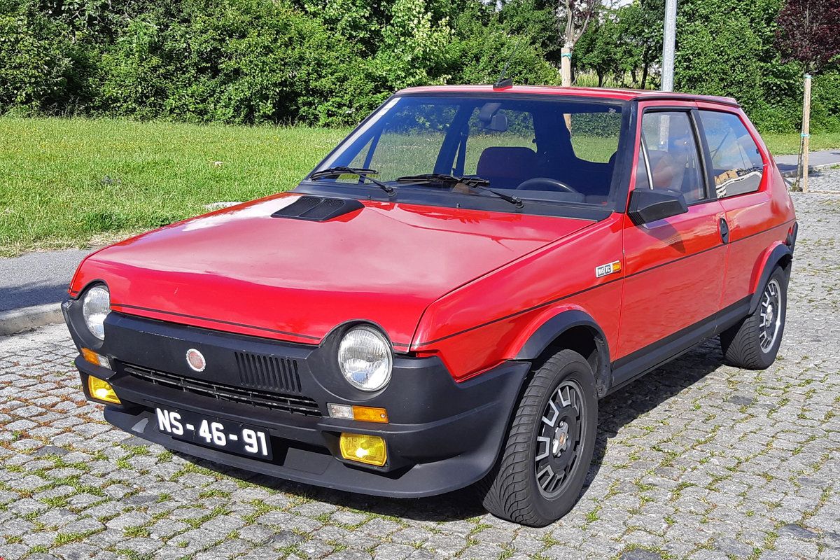 Red 1982 Fiat Ritmo Abarth parked on the stone pavers