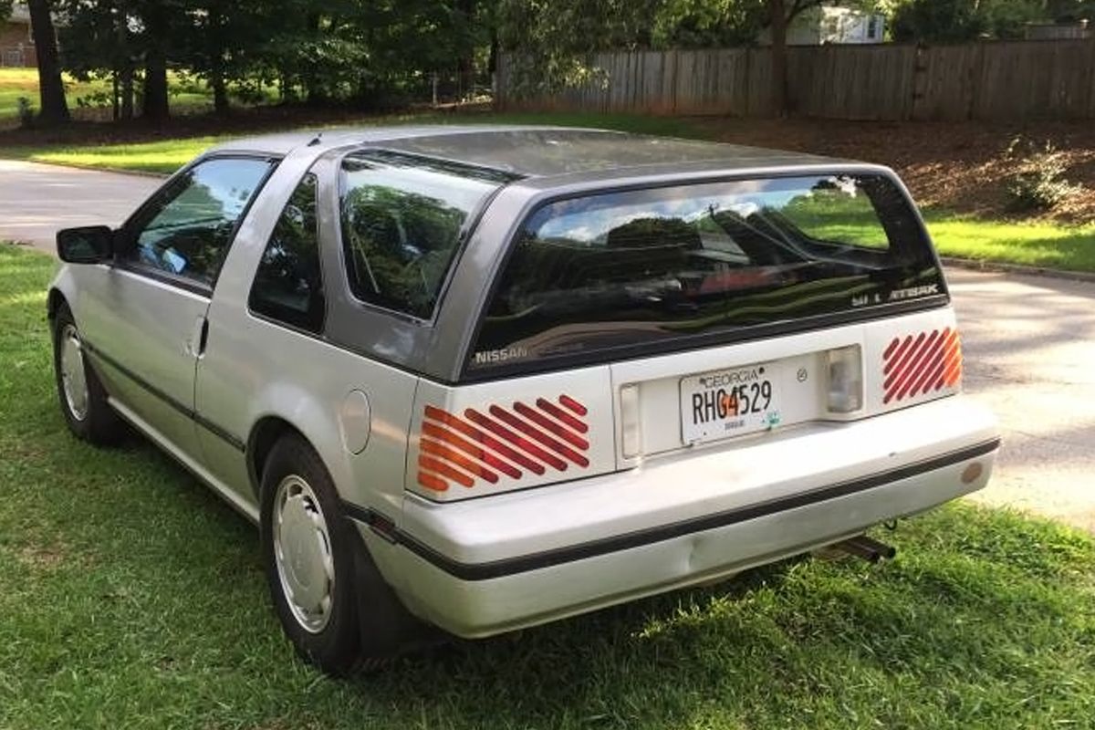 Silver Nissan Pulsar NX Sportbak parked on the lawns