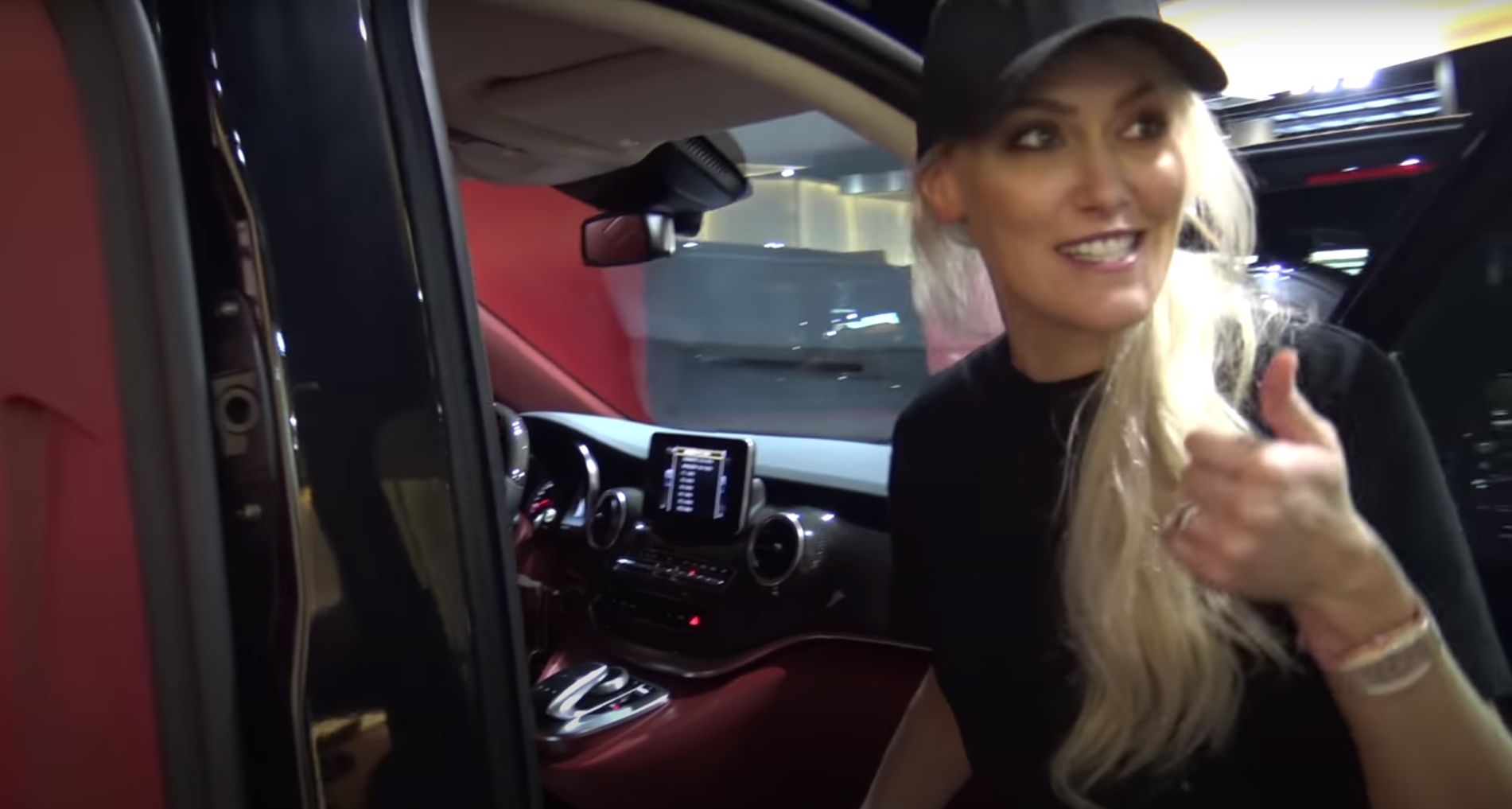 Supercar Blondie poses outside a Mercedes V-class van