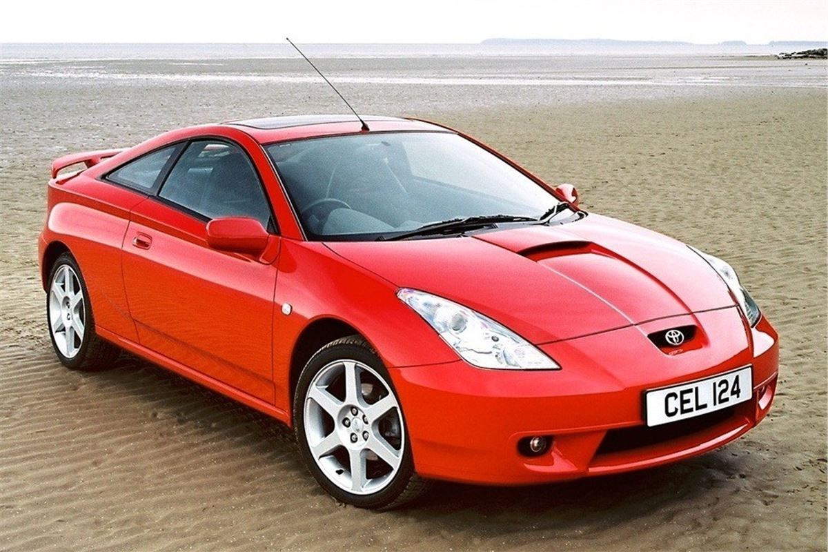 Absolutely Red Toyota Celica on a sandy beach
