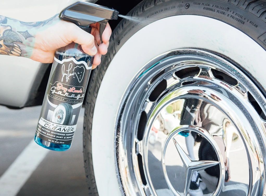 hand cleaning and spraying white wall tire