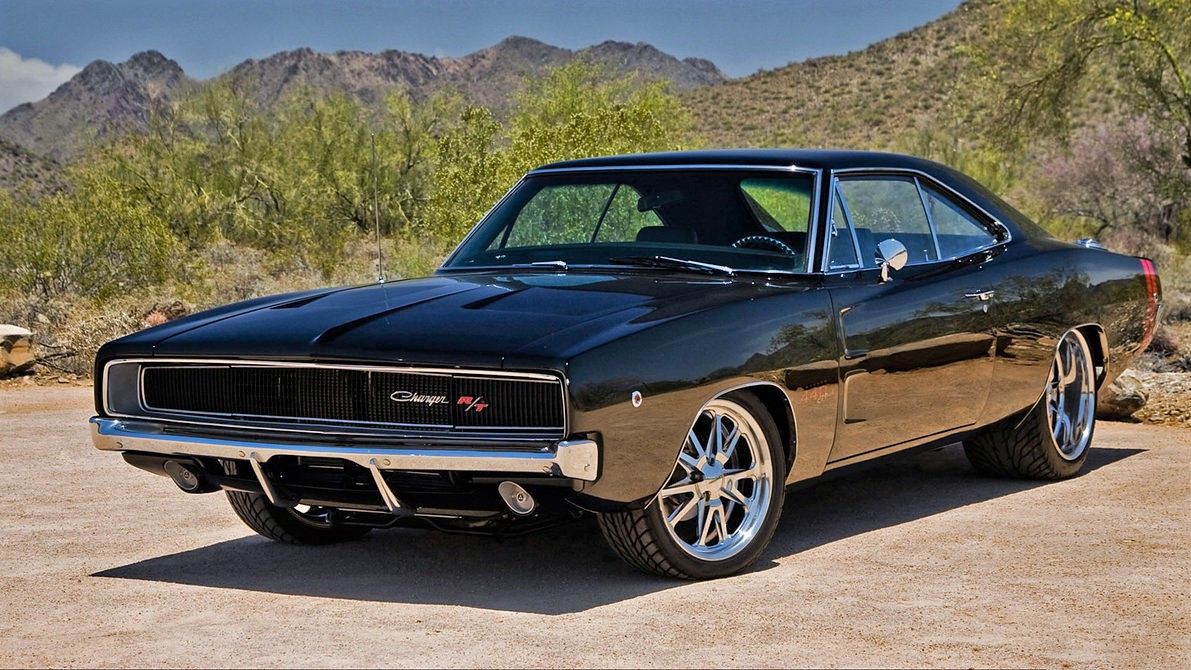 A black 1968 Dodge Charger stands parked on a road.