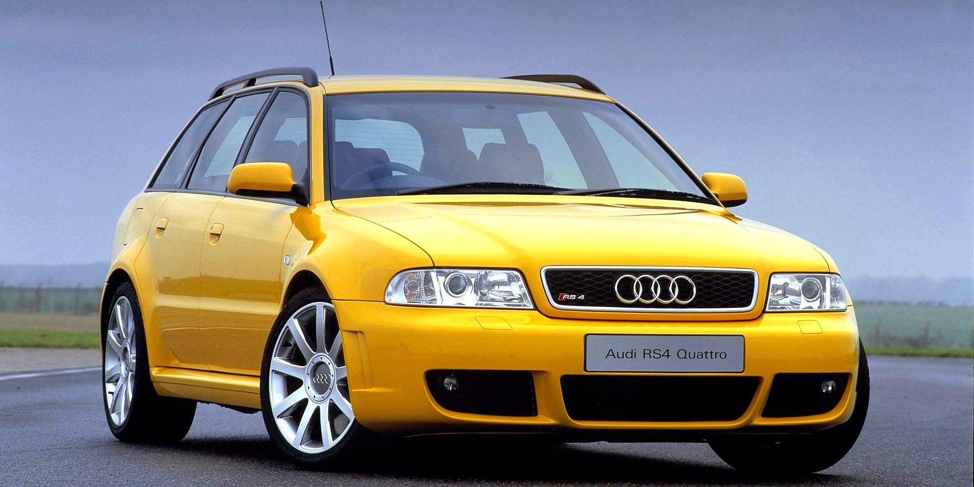 A yellow 2000 Audi RS4 Avant parked