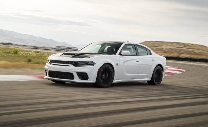 A 2021 Dodge Charger Scat Pack races down the road.