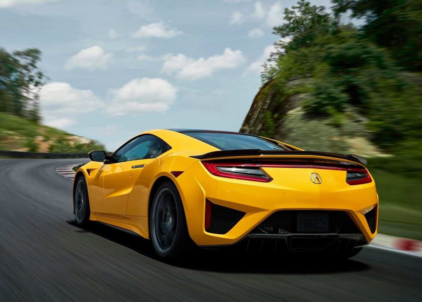 Indy Yellow Pearl Acura NSX speeding on the track