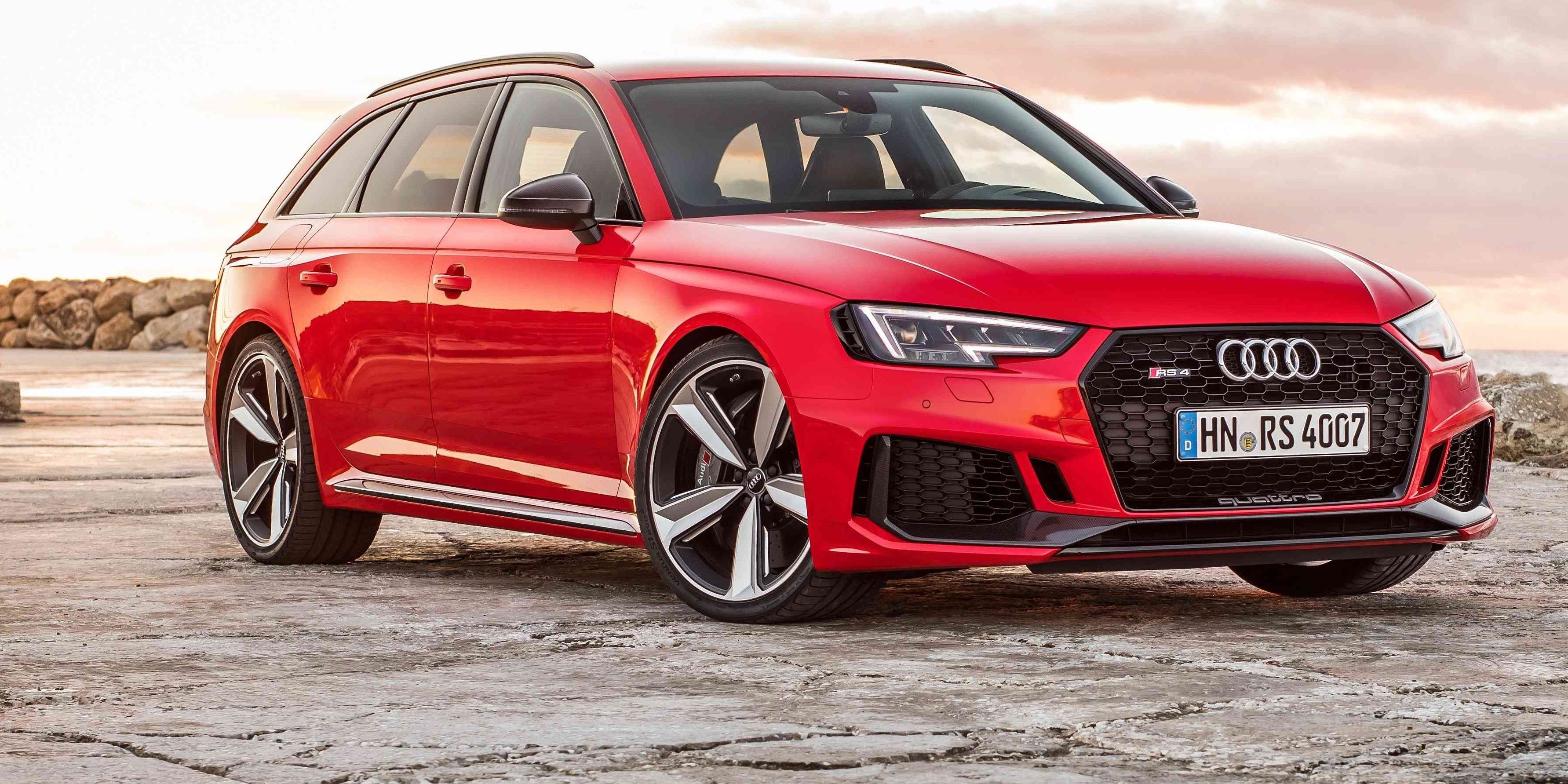 A bright red 2018 Audi RS4 Avant B9 parked on a stone floor