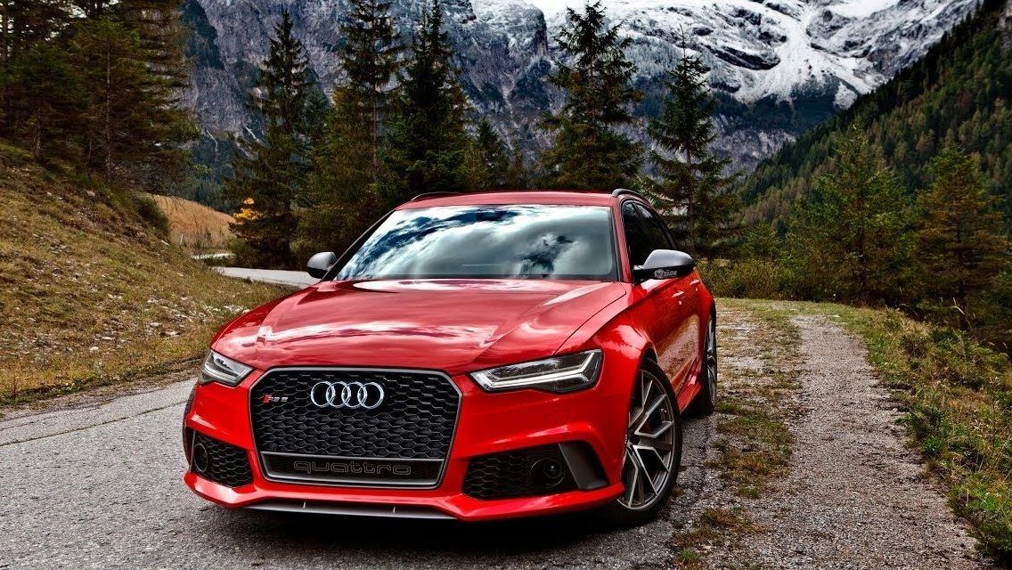 A red 2017 Audi RS6 Avant Performance parked in the Alps