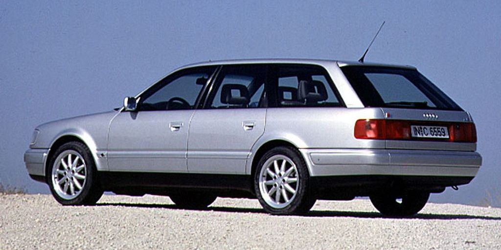 A silver 1996 Audi S6 Avant Plus C4 parked on pebbled ground