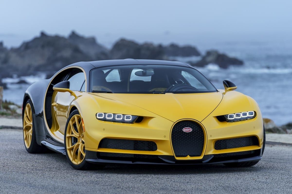 Yellow and black Bugatti Chiron parked on the seaside road