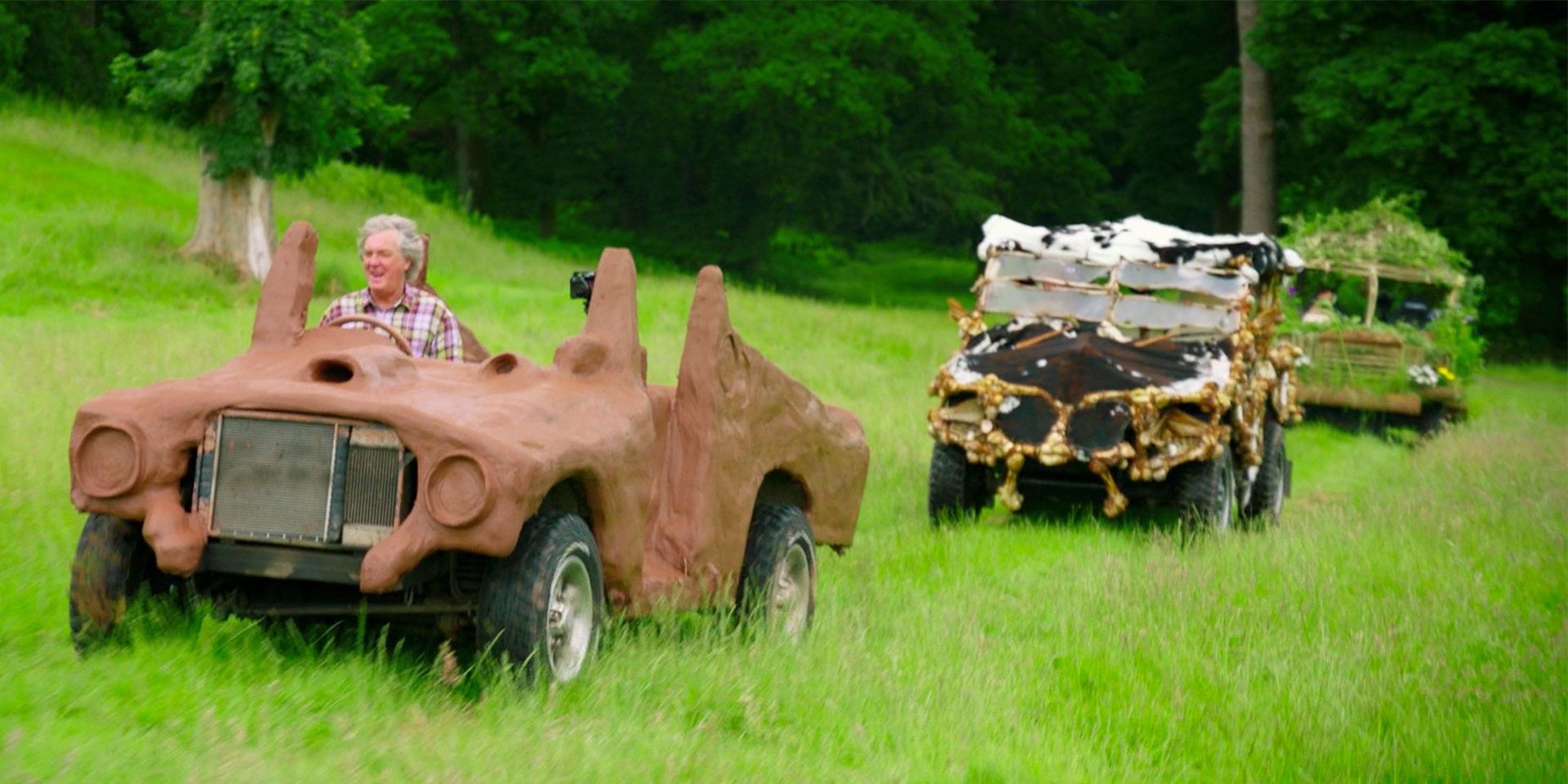 Three Eco-friendly cars made by Grand Tour hosts on a grassy field