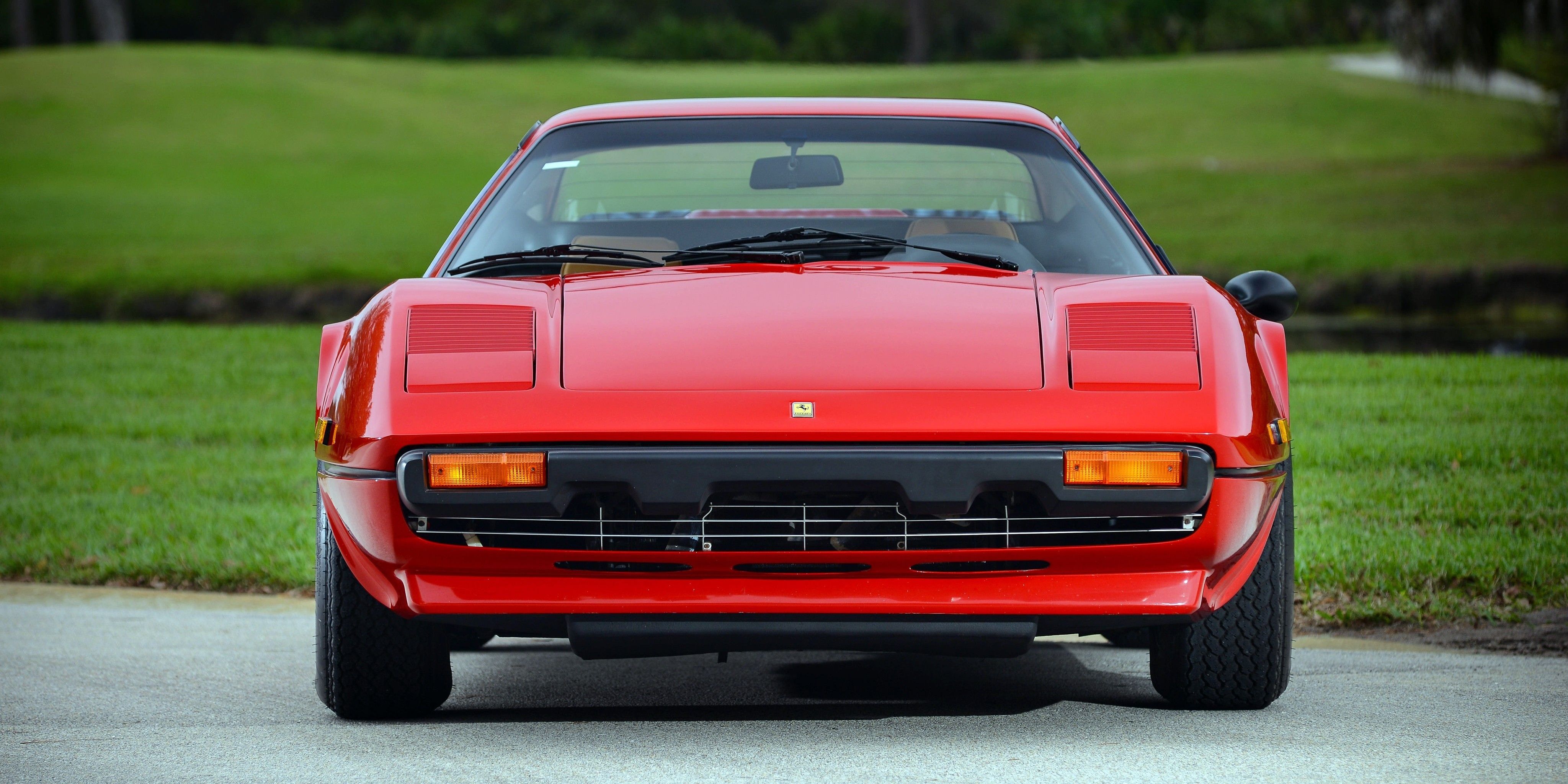 A Frontal Picture Of A Parked Red 1975 Ferrari 308 GTB