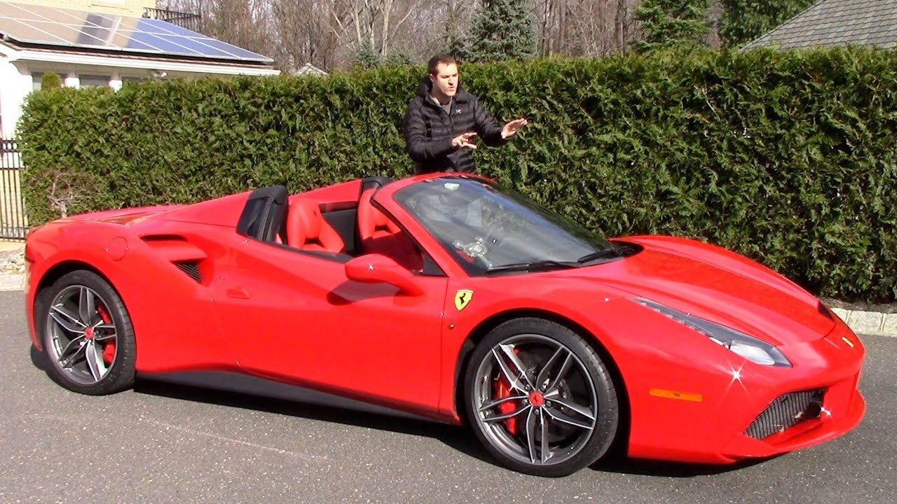 Red Ferrari 488 Spider with man standing next to it