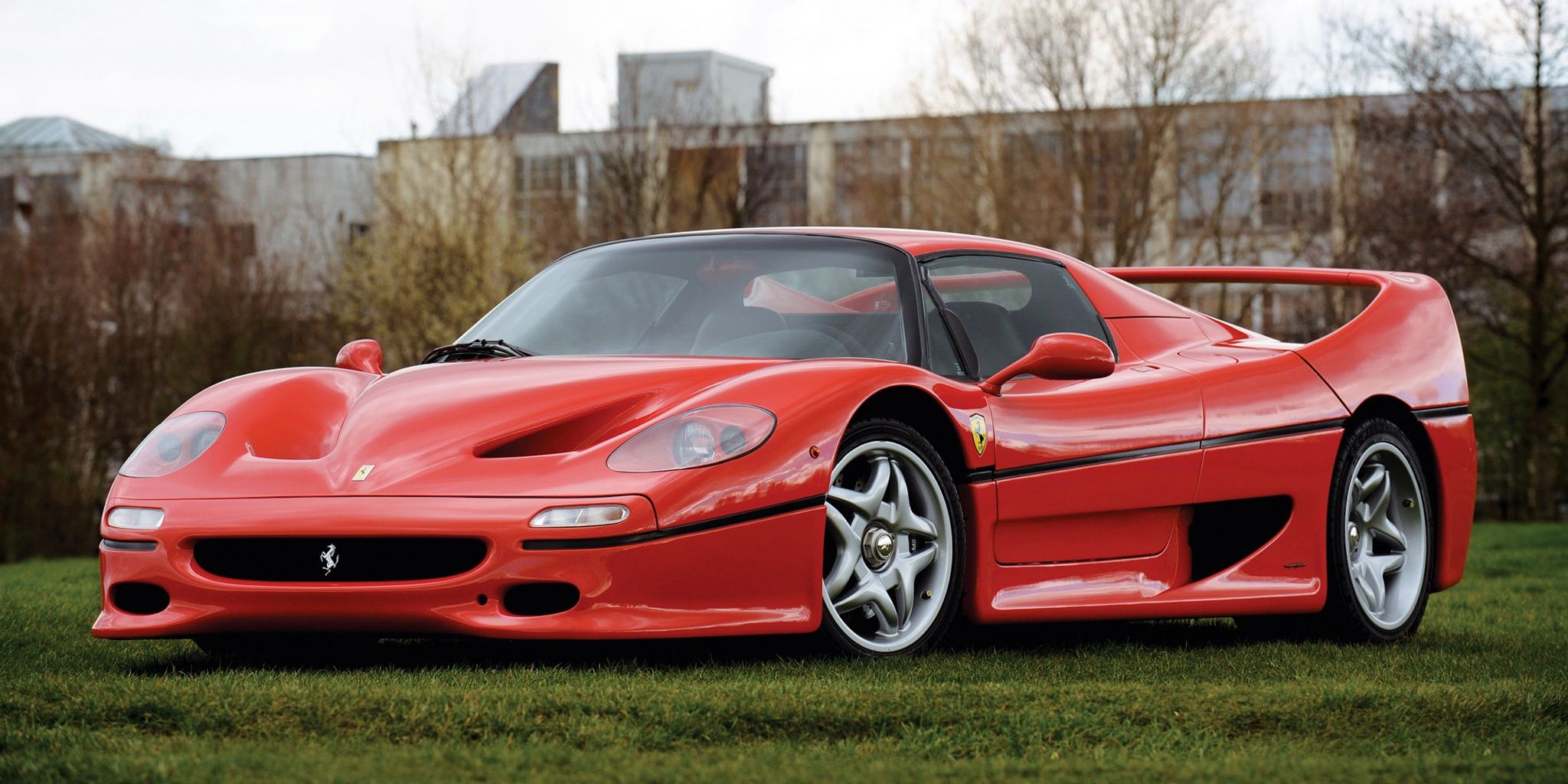 A red 1995 Ferrari F50 parked in a ground