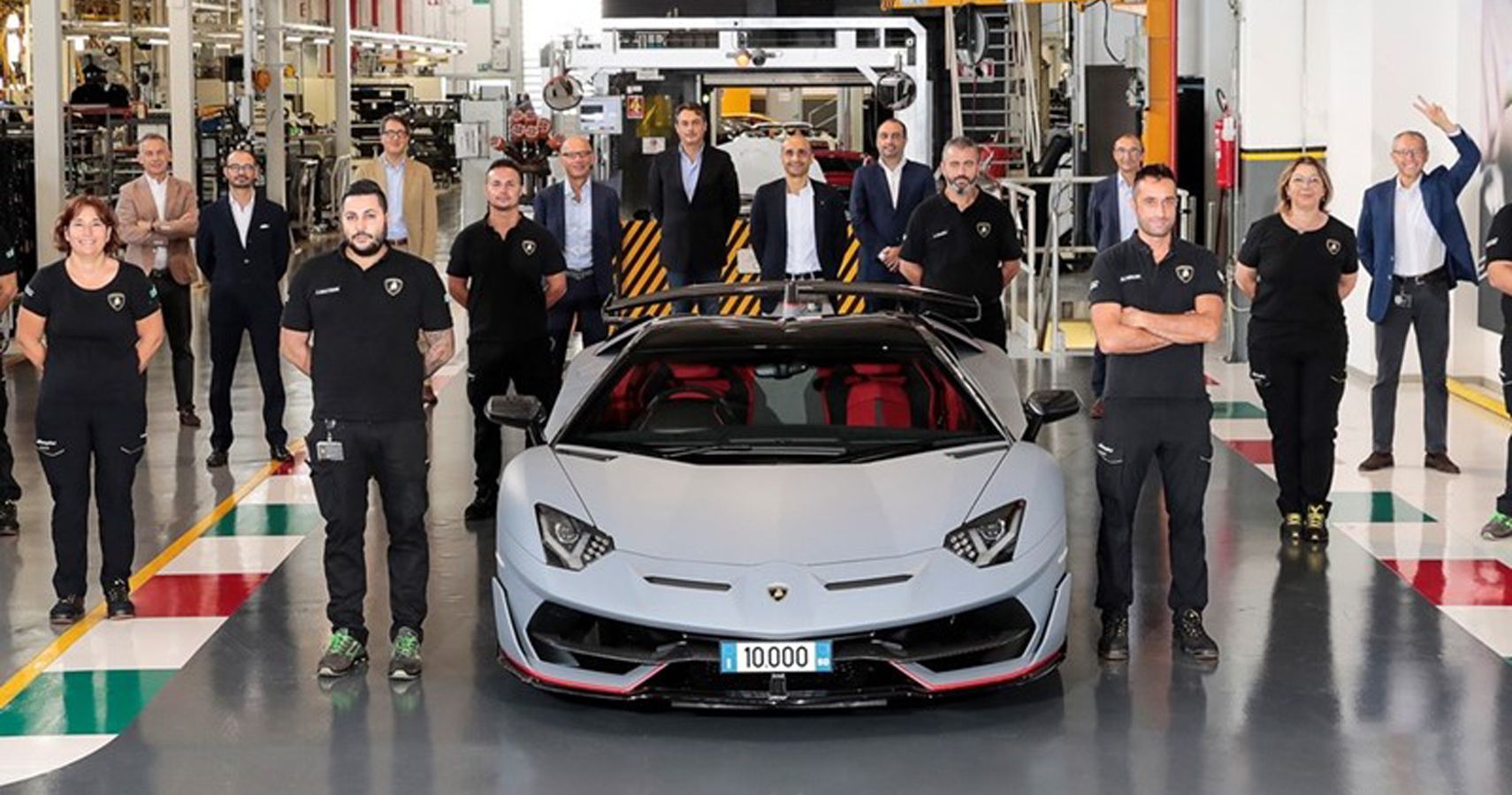 Lamborghini workers assemble beside 10000th rollout of Avent