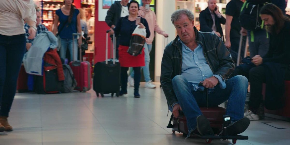 James May atop a motorized suitcase in London Stansted Airport