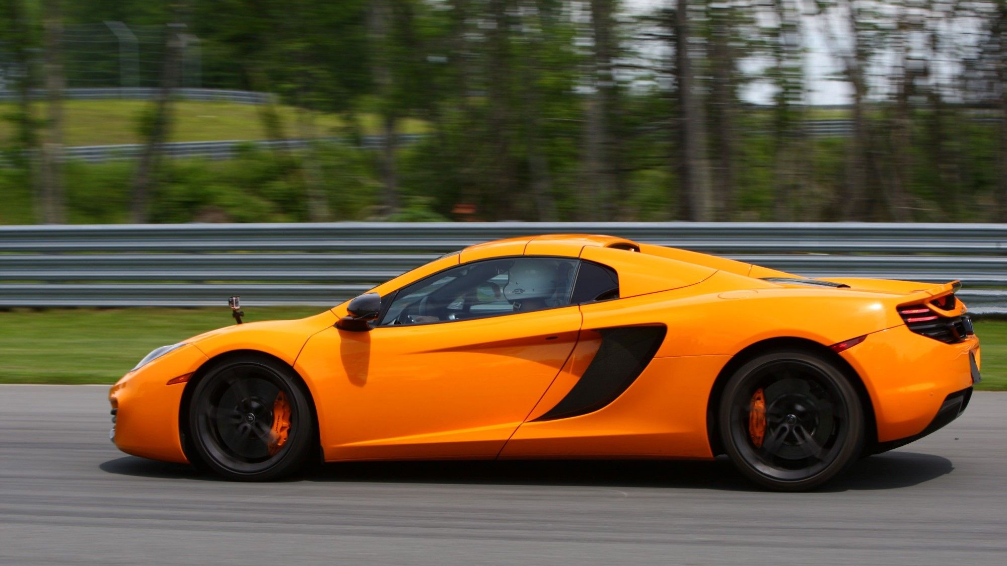 Side profile of a moving McLaren MP4-12C