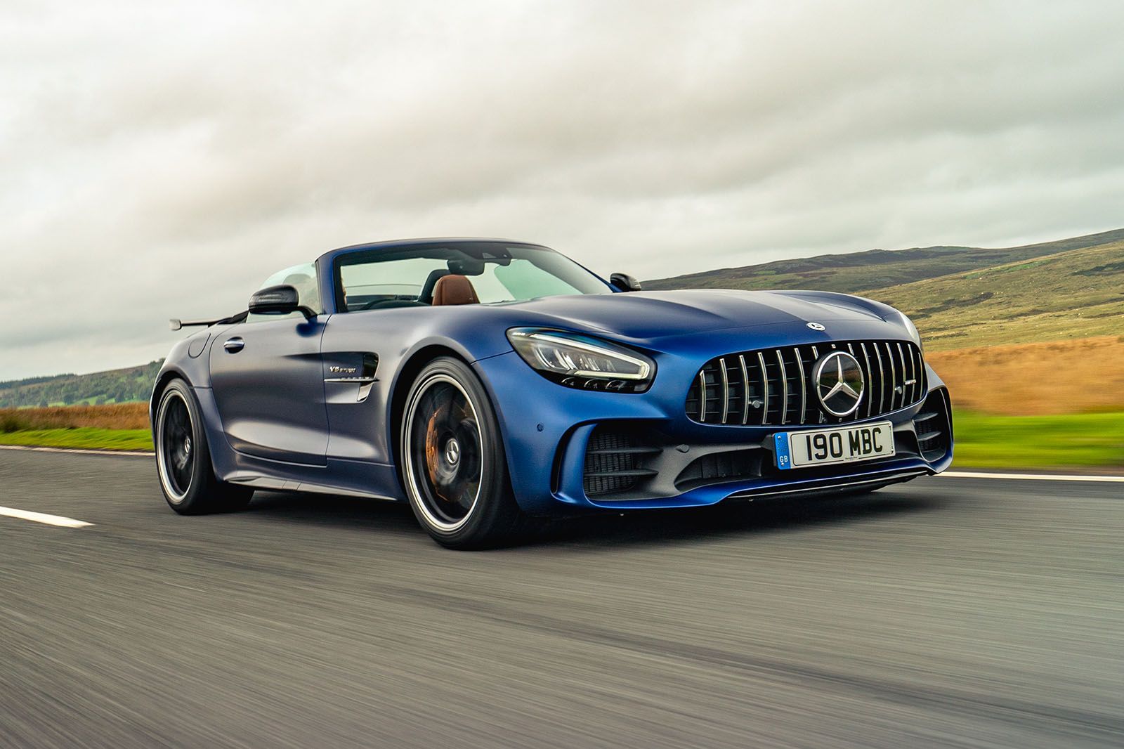 Designo Brilliant Blue Mercedes-AMG GT speeding on the country road
