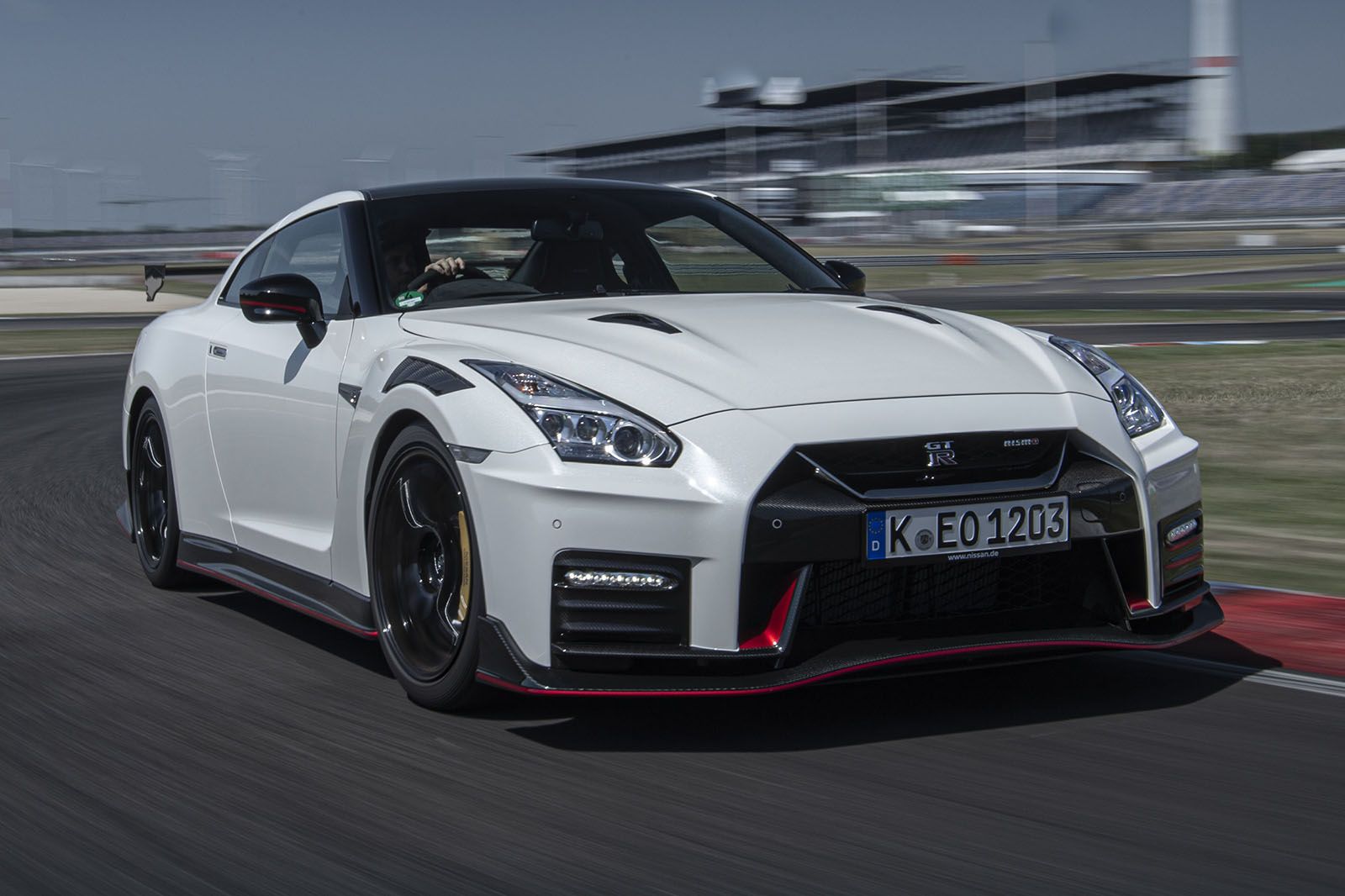 Pearl White Tricoat Nissan GT-R Nismo speeding on the track