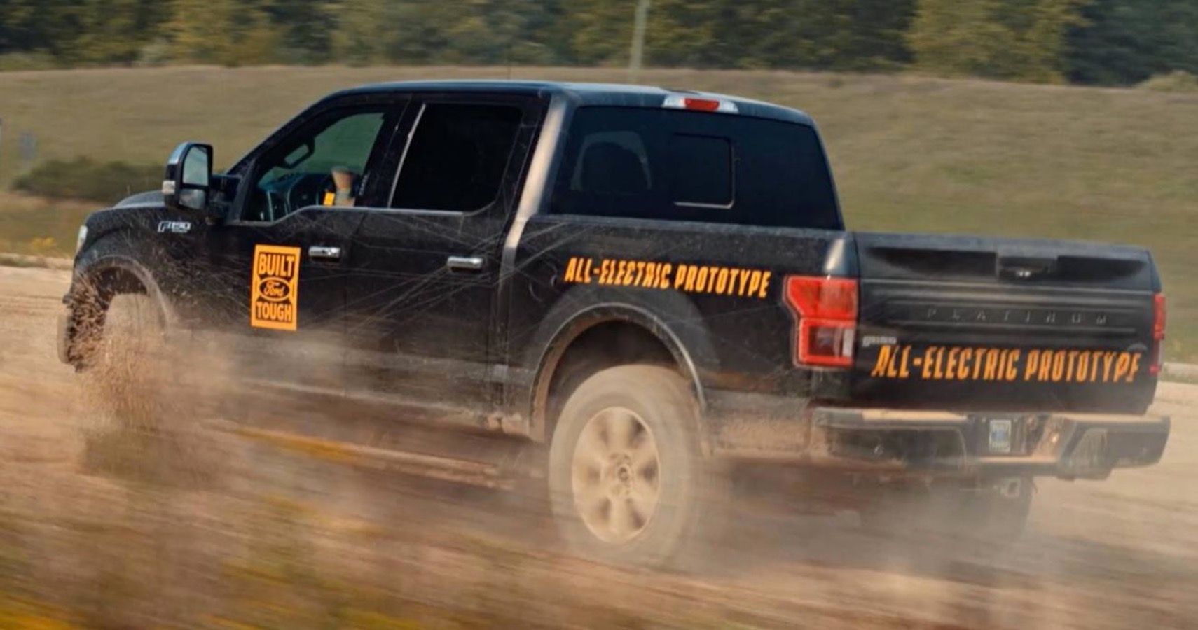 Electric Ford F-150 driving on dirt road