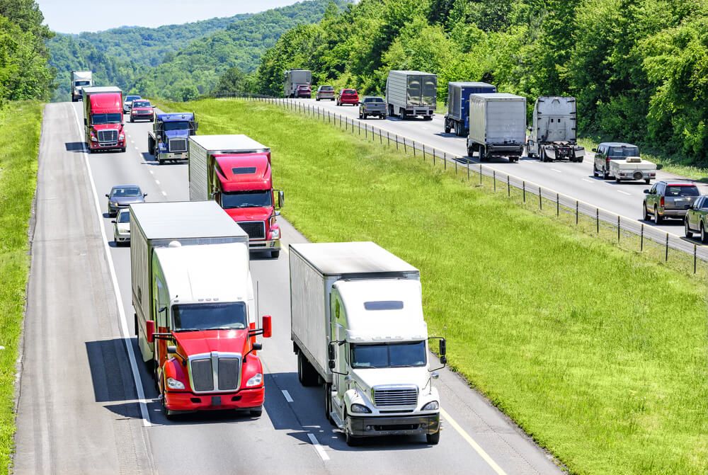 Trucks passing each other on highway.