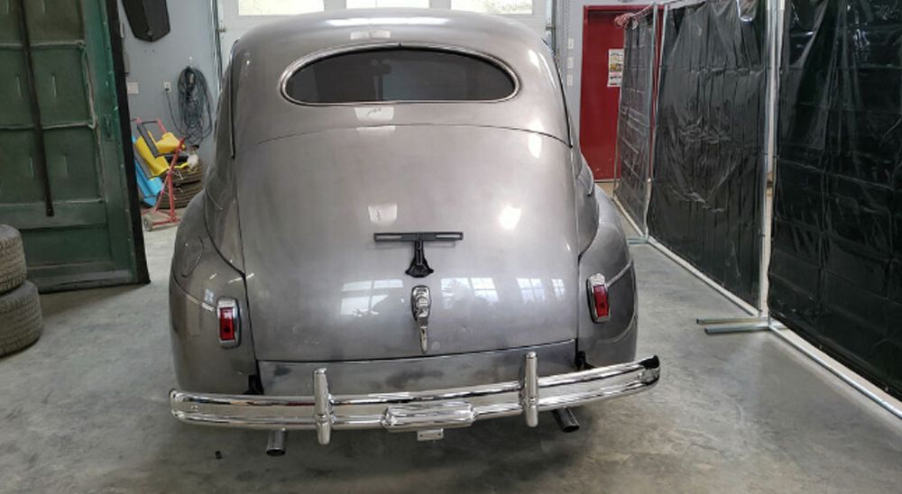 1941 Ford Super Deluxe in Rust Brothers garage rear view