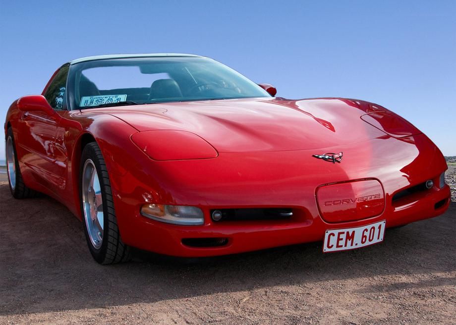 A 2004 Chevy Corvette C5 with pop-up headlights stands parked.