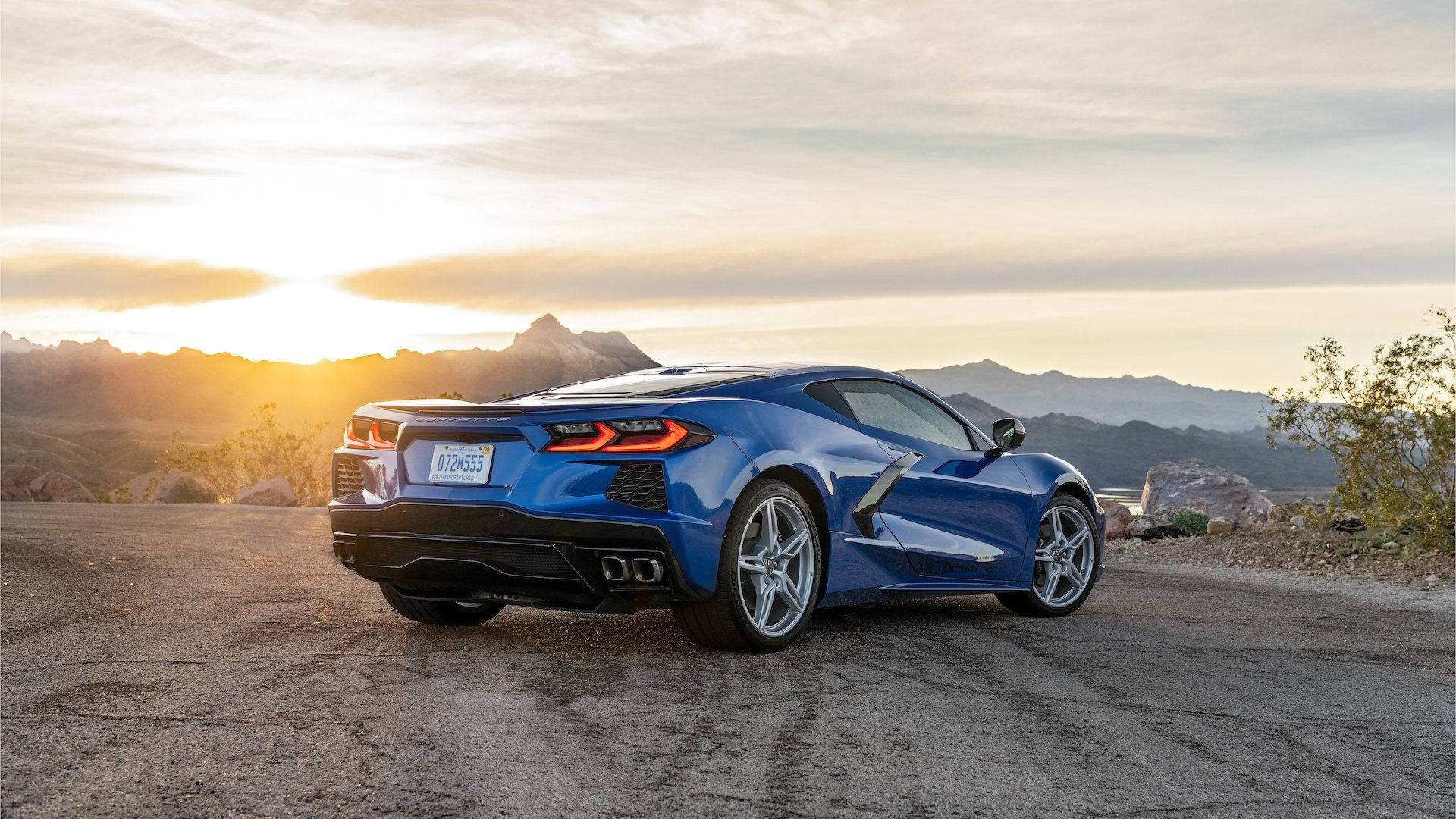 A 2021 blue Chevrolet Corvette C8 stands parked on a mountain.