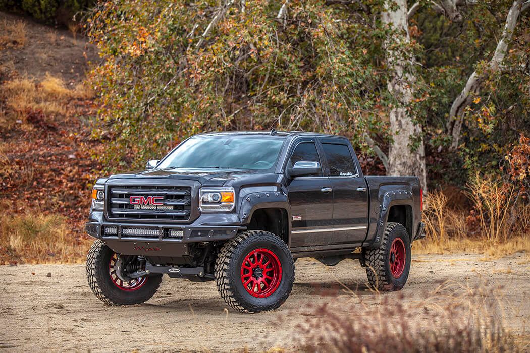 Lifted GMC pickup on a dirt road
