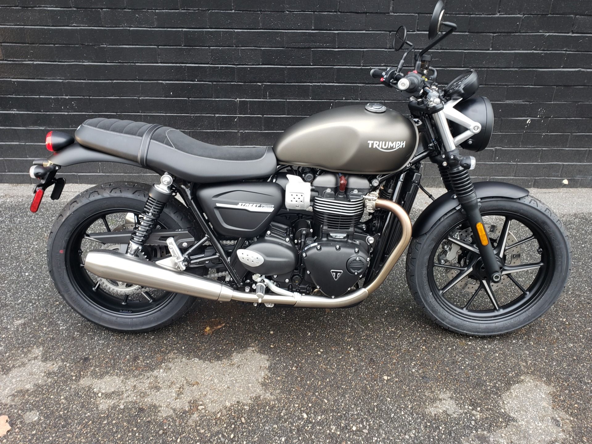 Triumph Street Twin parked next to a wall
